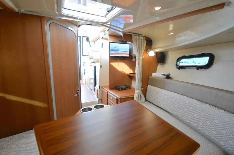 Chestnuts Yacht Photos Pics Interior of 2020 Ranger Tugs R-27 boat with wood finishes and seating area.