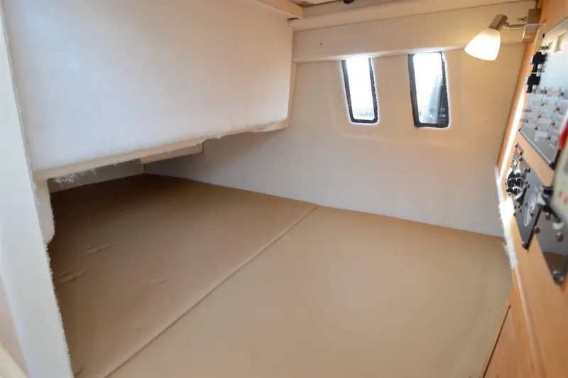 Chestnuts Yacht Photos Pics 2020 Ranger Tugs R-27 cabin interior with cozy sleeping area and natural light.