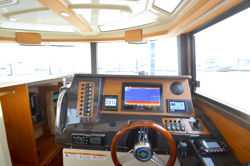 Chestnuts Yacht Photos Pics 2020 Ranger Tugs R-27 helm with navigation screens and controls.