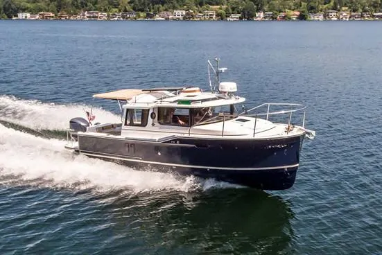 Chestnuts Yacht Photos Pics 2020 Ranger Tugs R-27 cruising on a lake with scenic shoreline in the background.