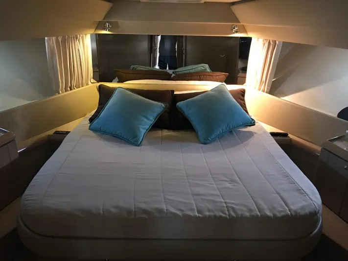  Yacht Photos Pics Luxurious bedroom interior of 2005 Ferretti Yachts 500 with elegant bedding and ambient lighting.