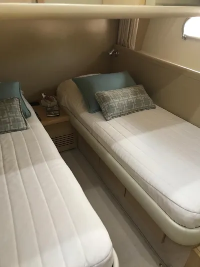  Yacht Photos Pics Twin beds in a 2005 Ferretti Yachts 500 cabin, featuring elegant bedding and soft lighting.