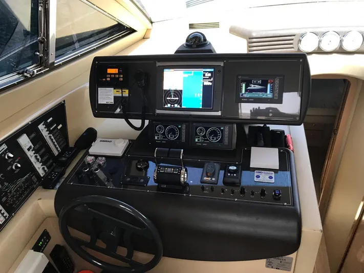  Yacht Photos Pics Control panel of a 2005 Ferretti Yachts 500, featuring navigation and monitoring systems.