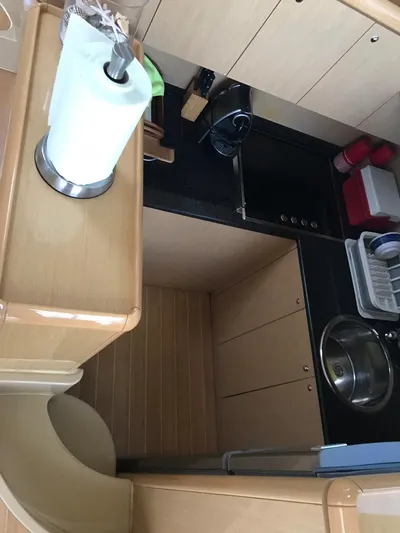  Yacht Photos Pics Compact kitchen area in a 2005 Ferretti Yachts 500, featuring modern amenities and sleek design.