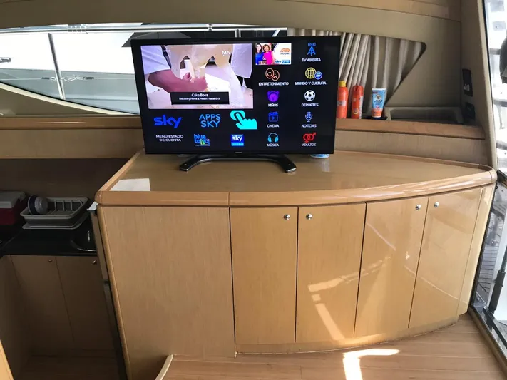  Yacht Photos Pics Luxurious interior of 2005 Ferretti Yachts 500 with modern TV and wooden cabinetry.