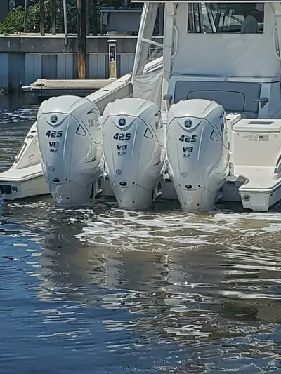 Fiji Kai Yacht Photos Pics 2023 Pursuit S378 boat with triple 425 V8 engines docked in calm water.