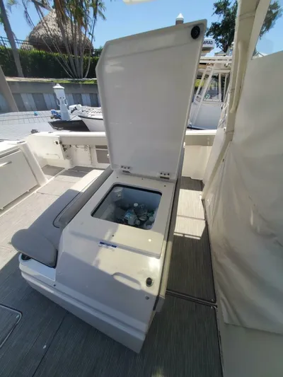 Fiji Kai Yacht Photos Pics 2023 Pursuit S378 boat with open storage compartment, revealing beverages inside.