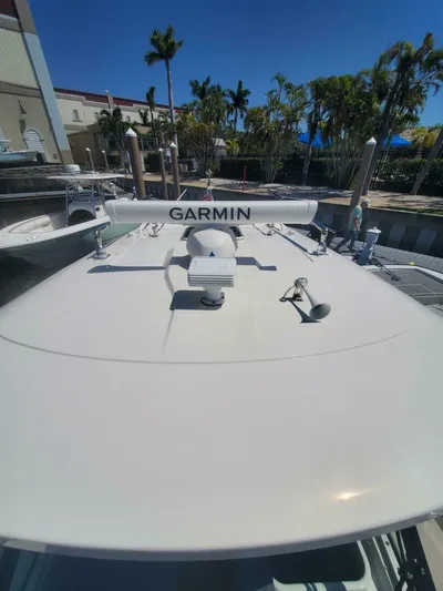 Fiji Kai Yacht Photos Pics 2023 Pursuit S378 boat with Garmin equipment, docked under clear blue sky.