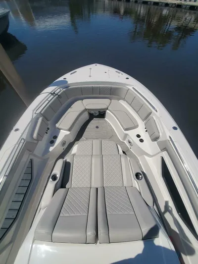 Fiji Kai Yacht Photos Pics 2023 Pursuit S378 boat with spacious seating and sleek design on calm water.