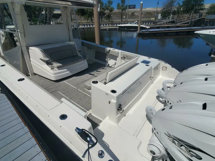 Fiji Kai Yacht Photos Pics 2023 Pursuit S378 boat with spacious deck and triple outboard engines docked at marina.