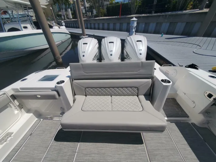 Fiji Kai Yacht Photos Pics 2023 Pursuit S378 boat with triple engines and cushioned seating at the dock.