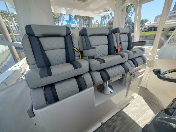 Fiji Kai Yacht Photos Pics Luxurious seating on 2023 Pursuit S378 boat, featuring quilted upholstery and modern design.