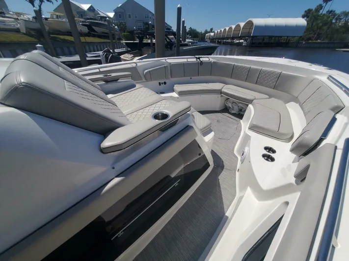 Fiji Kai Yacht Photos Pics 2023 Pursuit S378 boat with luxurious seating and modern design in a marina setting.