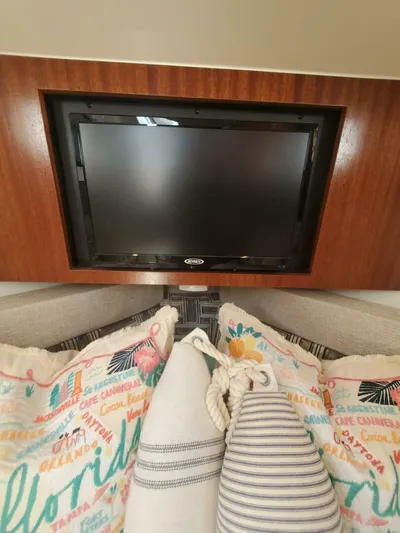 Fiji Kai Yacht Photos Pics 2023 Pursuit S378 interior with TV and decorative pillows.