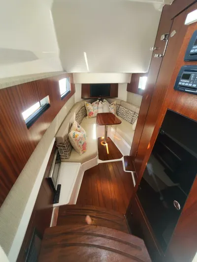 Fiji Kai Yacht Photos Pics 2023 Pursuit S378 boat interior with wood finish, cozy seating, and modern amenities.
