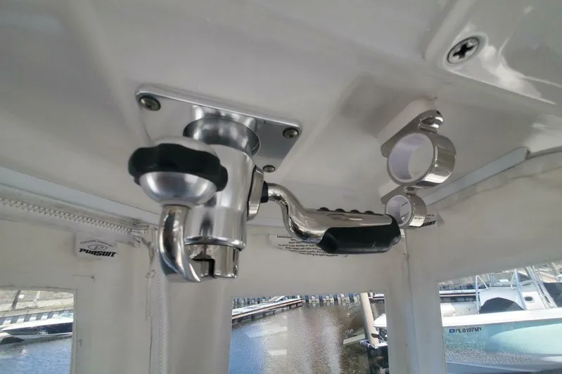 Fiji Kai Yacht Photos Pics 2023 Pursuit S378 boat interior, featuring stainless steel fixtures and rod holders.