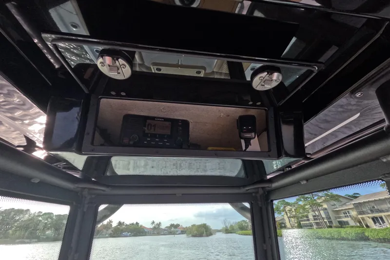  Yacht Photos Pics 2024 Caymas 281 HB boat interior with Garmin electronics and scenic waterway view.