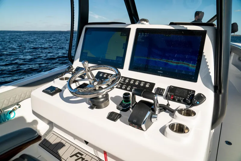  Yacht Photos Pics 2026 Front Runner 36 Center Console boat dashboard with dual screens and steering wheel.