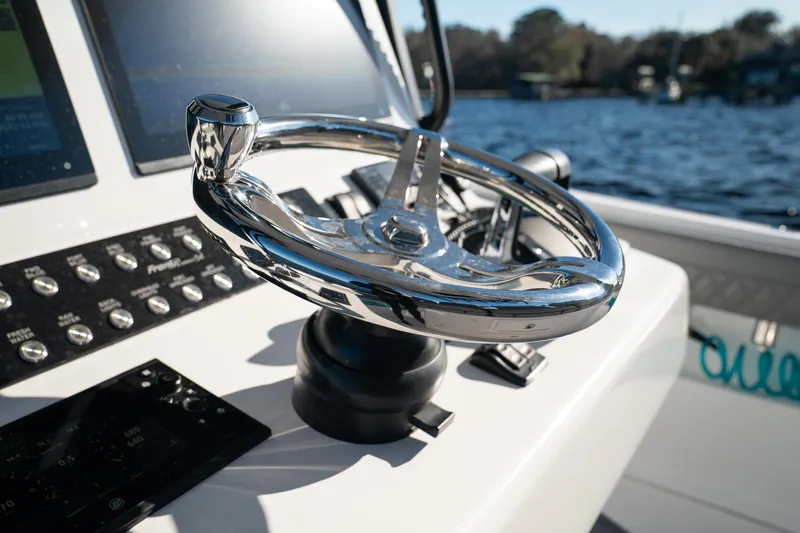  Yacht Photos Pics 2026 Front Runner 36 Center Console steering wheel with control panel, overlooking water.