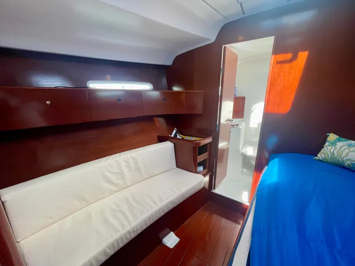 Caravan Yacht Photos Pics Interior of 2002 Beneteau First 47.7 yacht with wooden finish and cozy seating.