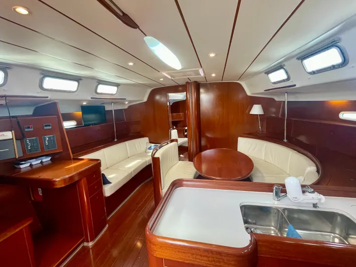 Caravan Yacht Photos Pics Luxurious interior of a 2002 Beneteau First 47.7 yacht with elegant wood finishes.