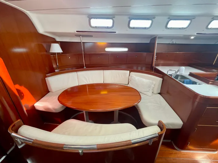 Caravan Yacht Photos Pics Luxurious interior of 2002 Beneteau First 47.7 yacht with elegant wood and leather seating.