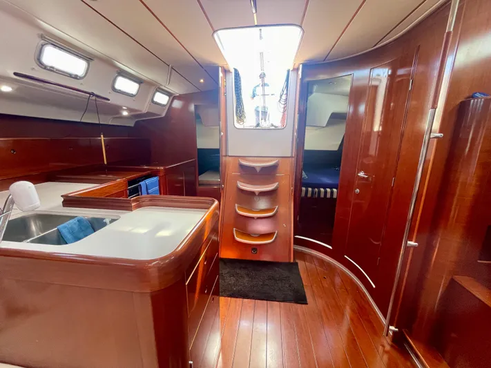 Caravan Yacht Photos Pics Interior of 2002 Beneteau First 47.7 yacht, featuring wood finishes and modern amenities.