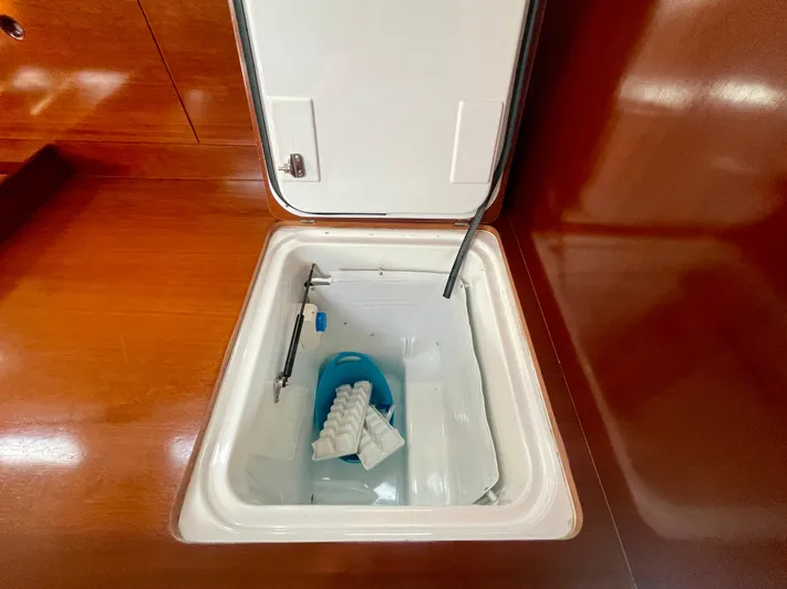 Caravan Yacht Photos Pics Storage compartment on a 2002 Beneteau First 47.7 yacht, featuring a blue container.