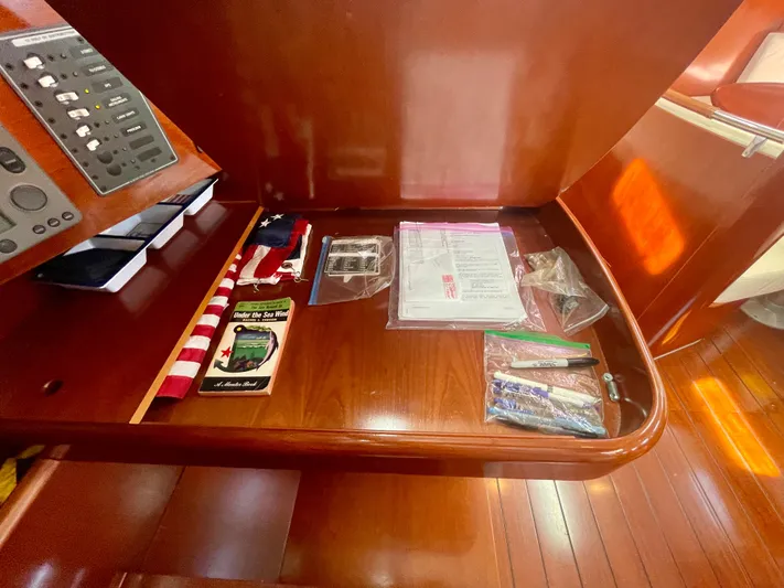 Caravan Yacht Photos Pics Navigation station on 2002 Beneteau First 47.7 yacht with equipment and documents.