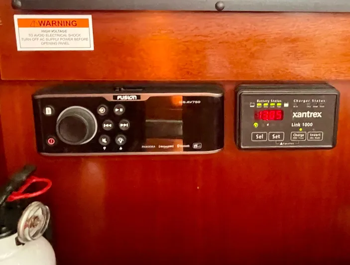 Caravan Yacht Photos Pics Control panel on a 2002 Beneteau First 47.7 yacht, featuring Fusion and Xantrex systems.