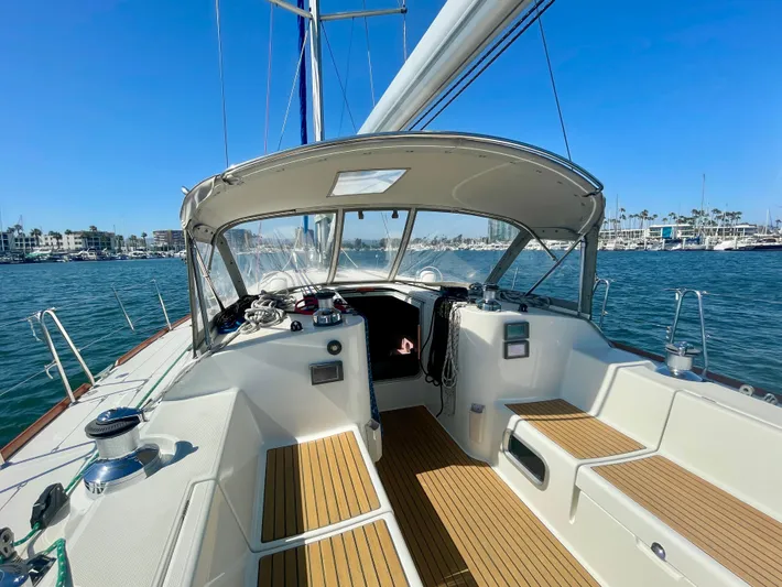 Caravan Yacht Photos Pics Beneteau First 47.7 sailboat cockpit, 2002 model, with teak seating and marina view.