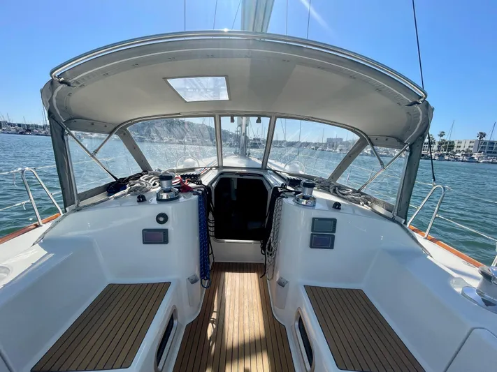 Caravan Yacht Photos Pics Beneteau First 47.7 sailboat cockpit, 2002 model, with wooden deck and marina view.