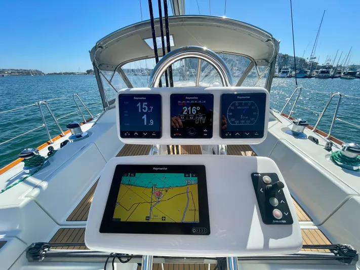 Caravan Yacht Photos Pics Beneteau First 47.7 yacht cockpit with navigation displays, 2002 model, on a sunny day at sea.
