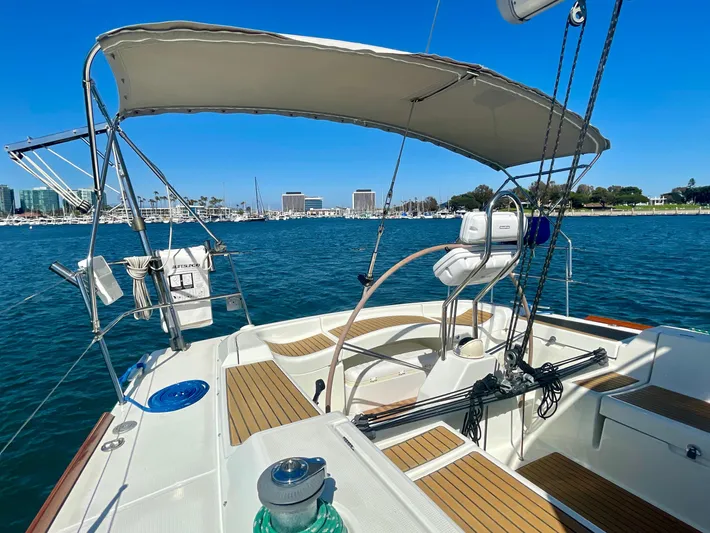 Caravan Yacht Photos Pics Beneteau First 47.7 sailboat, 2002 model, docked in a sunny marina with clear blue skies.