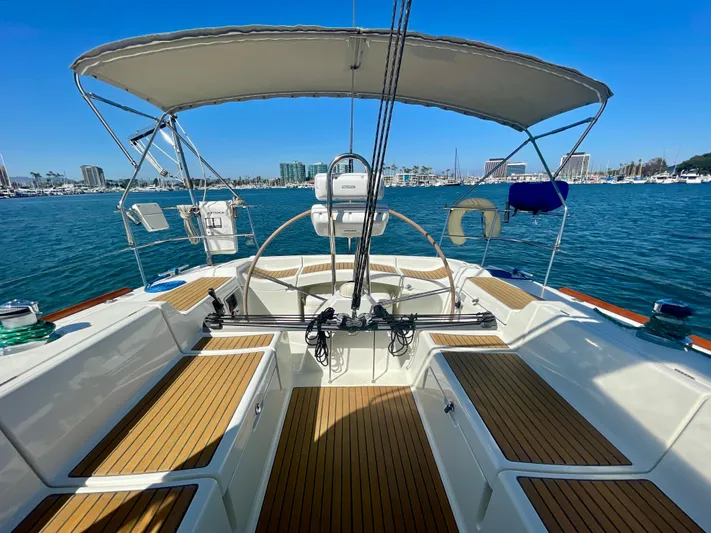 Caravan Yacht Photos Pics Cockpit of 2002 Beneteau First 47.7 sailboat with teak flooring and marina view.