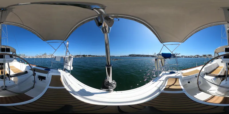 Caravan Yacht Photos Pics 2002 Beneteau First 47.7 sailboat deck with dual steering wheels, under sunny skies.