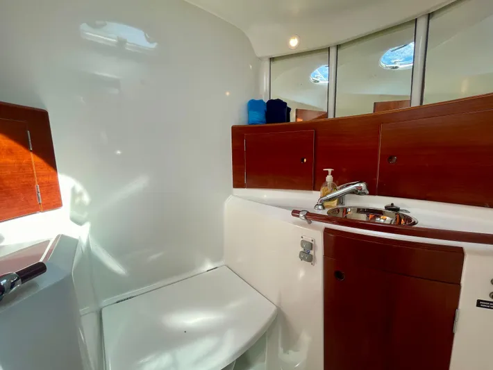 Caravan Yacht Photos Pics Beneteau First 47.7 2002 yacht bathroom with wooden cabinets and modern fixtures.