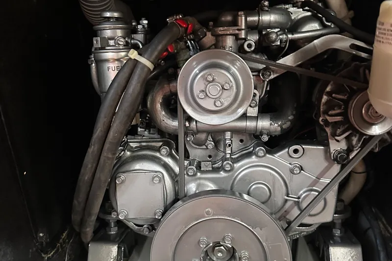 Caravan Yacht Photos Pics Engine of a 2002 Beneteau First 47.7 sailboat, showcasing mechanical components and belts.