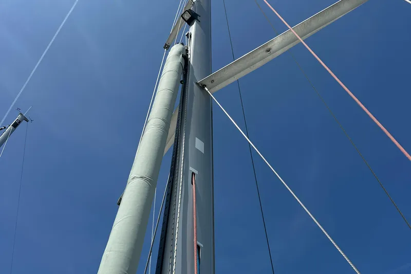 Caravan Yacht Photos Pics Mast of 2002 Beneteau First 47.7 sailboat against clear blue sky.