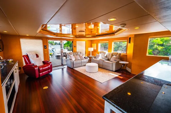 Lone Star Yacht Photos Pics Luxurious 1995 Hatteras Motor Yacht interior with elegant seating and polished wood flooring.