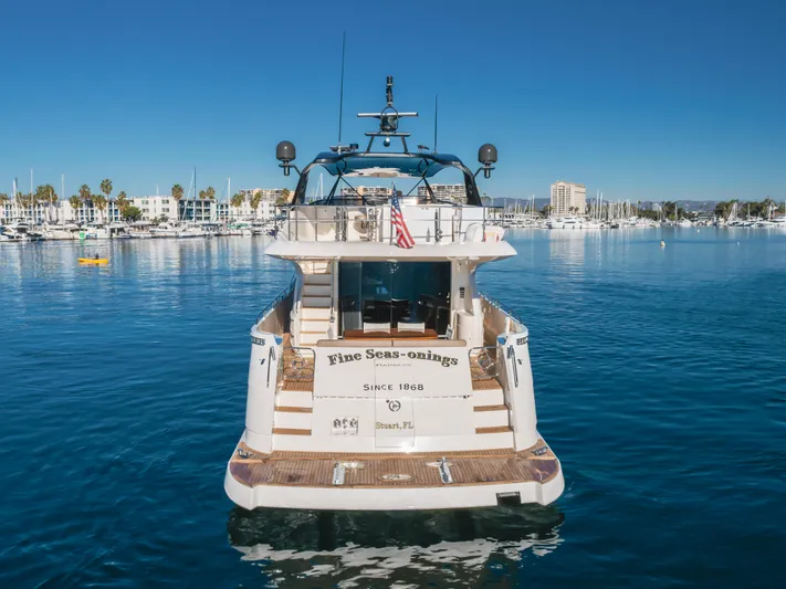 Fine Seas-onings Yacht Photos Pics 2018 Marquis 720 Fly yacht on calm water, marina in background.