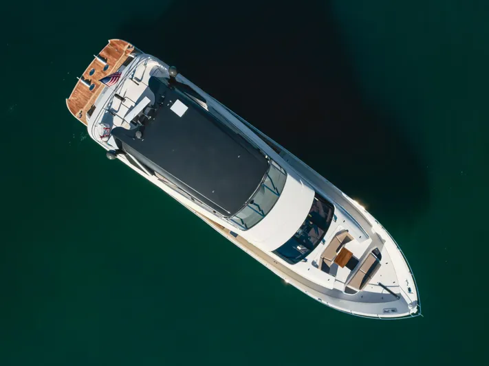 Fine Seas-onings Yacht Photos Pics Aerial view of 2018 Marquis 720 Fly yacht on calm water.