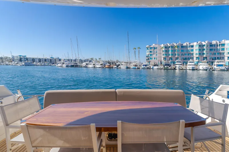 Fine Seas-onings Yacht Photos Pics Luxury yacht Marquis 720 Fly 2018, docked with marina view and elegant outdoor seating.