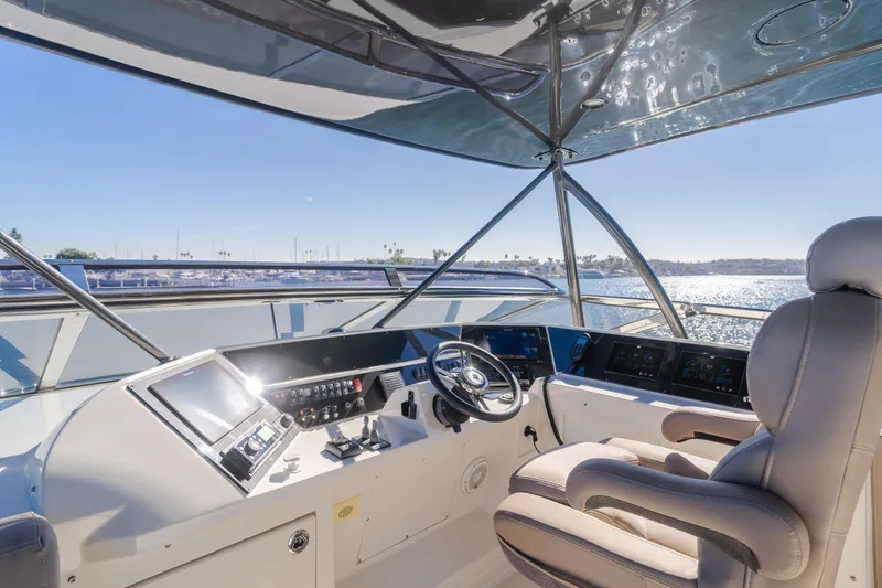Fine Seas-onings Yacht Photos Pics Cockpit of 2018 Marquis 720 Fly yacht with modern controls and panoramic view.