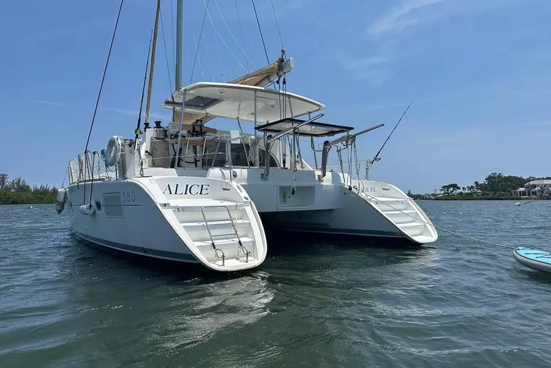 Alice Yacht Photos Pics 2015 Lagoon 380 S2 catamaran named "Alice" anchored on calm waters.