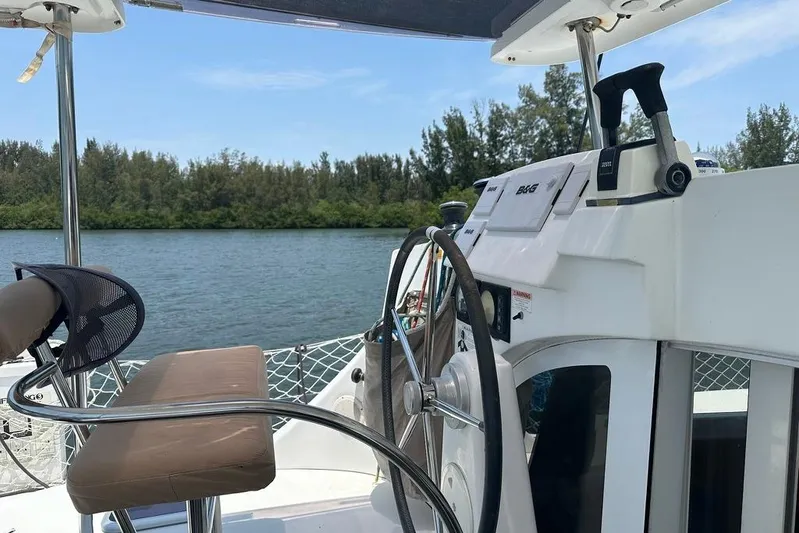 Alice Yacht Photos Pics Helm of 2015 Lagoon 380 S2 catamaran with scenic waterway view.