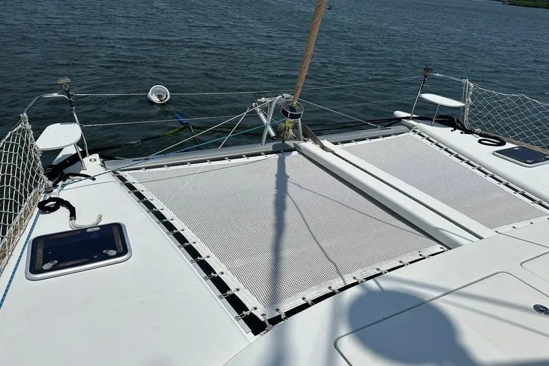 Alice Yacht Photos Pics 2015 Lagoon 380 S2 catamaran deck with netting over water.