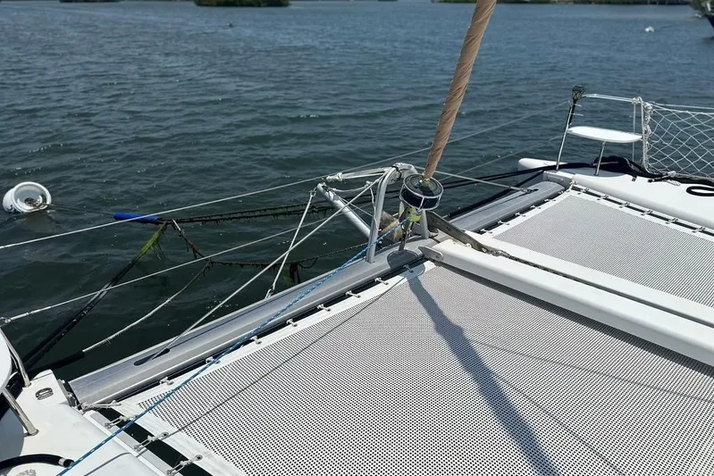 Alice Yacht Photos Pics 2015 Lagoon 380 S2 catamaran deck with netting on calm water.
