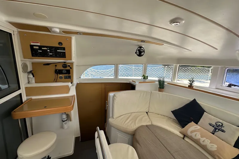 Alice Yacht Photos Pics Interior of 2015 Lagoon 380 S2 catamaran with cozy seating and nautical decor.