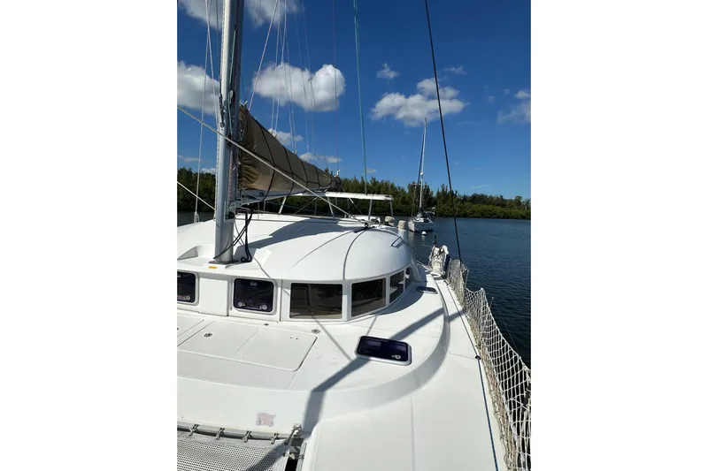Alice Yacht Photos Pics 2015 Lagoon 380 S2 catamaran on calm water under blue sky.
